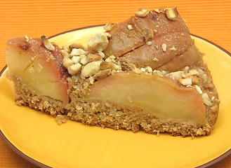 Image showing One slice of a wholemeal apple cake on orange placemat