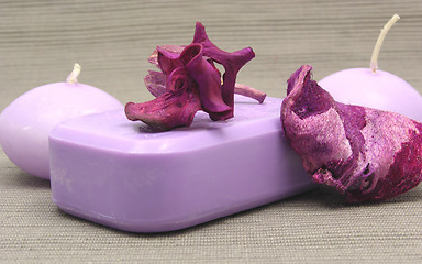 Image showing Lilac soap with decoration articles on a  gray  background