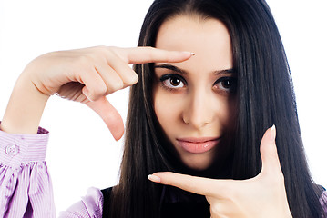 Image showing Pretty girl with frame gesture. Focus on fingers