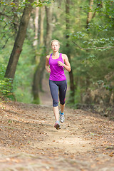 Image showing Pretty young girl runner in the forest. 