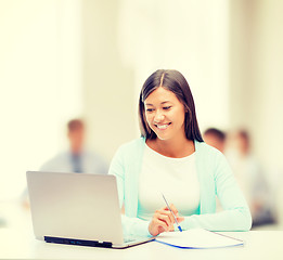 Image showing asian businesswoman with laptop and documents