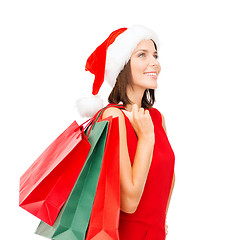 Image showing woman in red dress with shopping bags