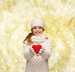 Image showing dreaming girl in winter clothes with red heart