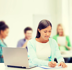 Image showing asian businesswoman with laptop and documents