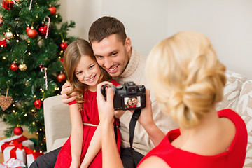 Image showing mother taking picture of father and daughter