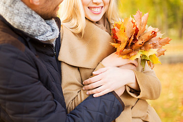 Image showing close up of smiling couple hugging in autumn park