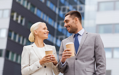 Image showing smiling businessmen with paper cups outdoors