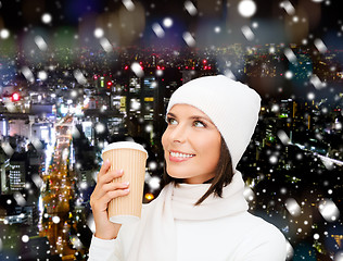 Image showing smiling young woman in winter clothes with cup