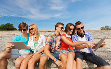 Image showing group of smiling friends with tablet pc outdoors