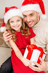 Image showing smiling father and daughter holding gift box