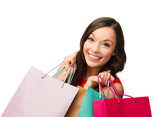 Image showing woman in red dress with shopping bags