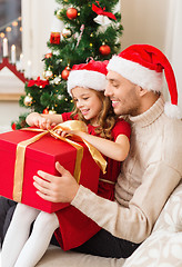 Image showing smiling father and daughter opening gift box