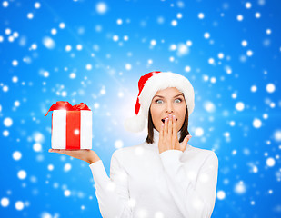 Image showing smiling woman in santa helper hat with gift box