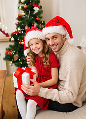 Image showing smiling father and daughter holding gift box