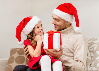 Image showing smiling father giving daughter gift box