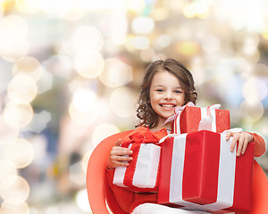 Image showing smiling little girl with gift boxes