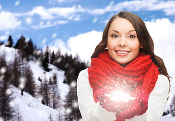 Image showing smiling woman in winter clothes with snowflake