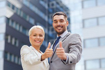 Image showing smiling businessmen showing thumbs up