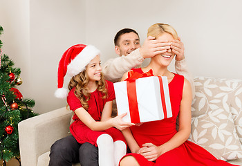 Image showing father and daughter surprise mother with gift box