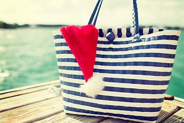 Image showing close up of beach bag and santa helper hat