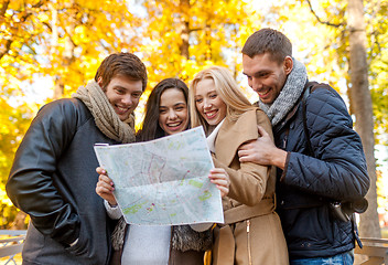 Image showing group of friends with map outdoors