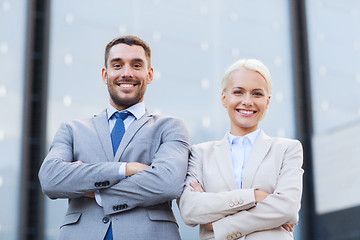 Image showing smiling businessman and businesswoman outdoors