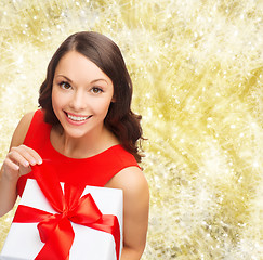 Image showing smiling woman in red dress with gift box