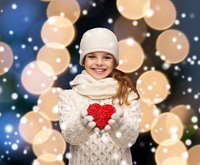 Image showing girl in winter clothes with small red heart