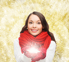 Image showing smiling woman in winter clothes with snowflake