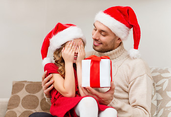 Image showing smiling daughter waiting for a present from father