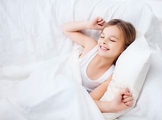 Image showing smiling girl child waking up in bed at home