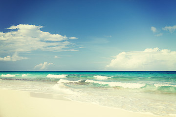 Image showing blue sea or ocean, white sand and sky with clouds