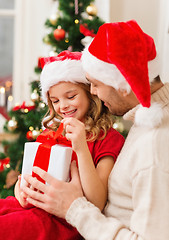 Image showing smiling father and daughter opening gift box