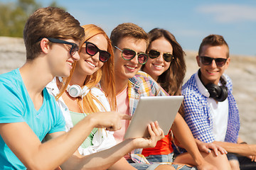 Image showing group of smiling friends with tablet pc outdoors