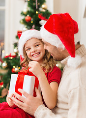 Image showing smiling father and daughter opening gift box