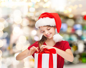 Image showing smiling girl in santa helper hat with gift box