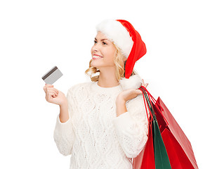 Image showing woman with shopping bags and credit card