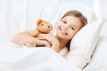 Image showing little girl with teddy bear sleeping at home