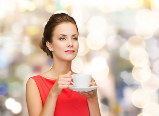 Image showing smiling woman in red dress with cup of coffee