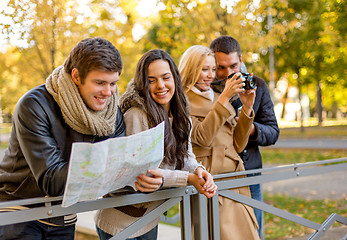 Image showing group of friends with map and camera outdoors