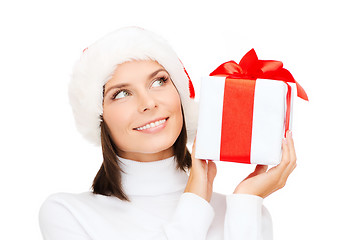 Image showing smiling woman in santa helper hat with gift box