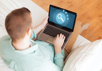 Image showing close up of man working with laptop at home