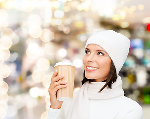 Image showing smiling young woman in winter clothes with cup