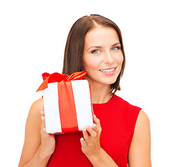 Image showing smiling woman in red dress with gift box