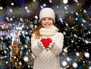 Image showing dreaming girl in winter clothes with red heart