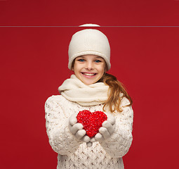 Image showing girl in winter clothes with small red heart