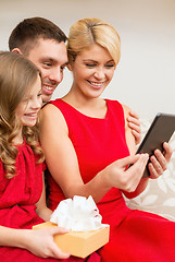 Image showing smiling family with tablet pc