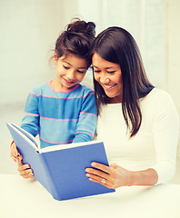 Image showing mother and daughter with book