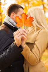 Image showing close up of couple kissing in autumn park