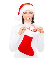 Image showing woman in santa hat with gift box and stocking